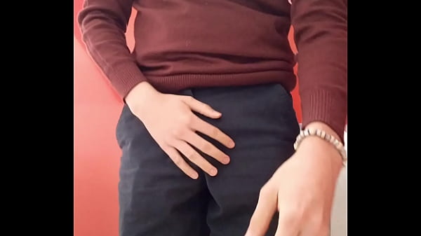 Young boy showing his chastity cage in school’s bathroom